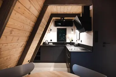 a kitchen with a sink and a counter top at Budzi nas las Marcyporeba - Mały domek in Marcyporęba