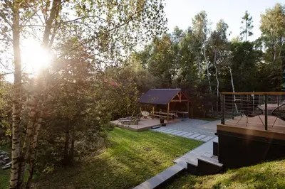 a living room with a couch and a table at Budzi nas las Marcyporeba - Mały domek in Marcyporęba
