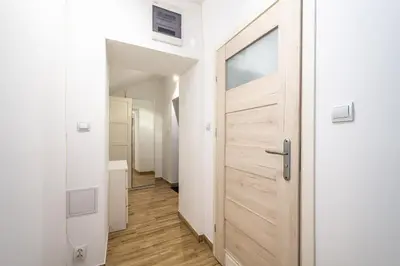 a door leading into a hallway with a bathroom at RentPlanet - Studio Mazowiecka in Kraków