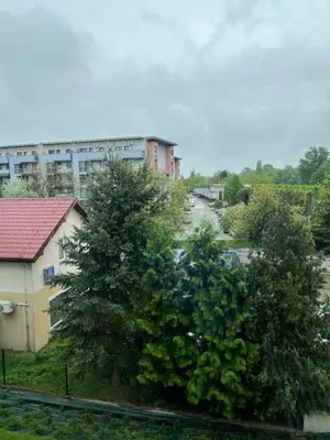 a view of a street with trees and a building at Loft Apartment in Kraków