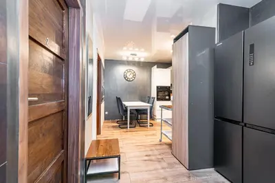 a hallway with a table and a dining room at Loft Apartment in Kraków