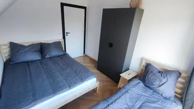 a bedroom with two beds with blue pillows at Stodoła pod Bacówką Zawoja Sauna Jacuzzi in Skawica