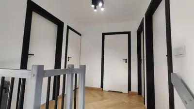 a hallway with three doors in a white wall at Stodoła pod Bacówką Zawoja Sauna Jacuzzi in Skawica