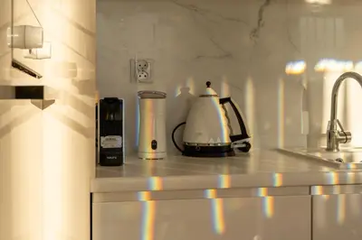 a kitchen counter with a toaster and a coffee maker at Malila Premium Apartments Cracow Masarska 11 in Kraków