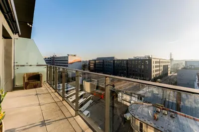 a balcony with a view of a city at Malila Premium Apartments Cracow Masarska 11 in Kraków