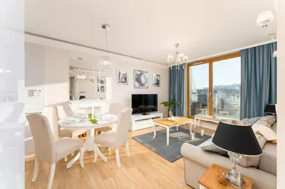 a living room with a couch and a table at Malila Premium Apartments Cracow Masarska 11 in Kraków