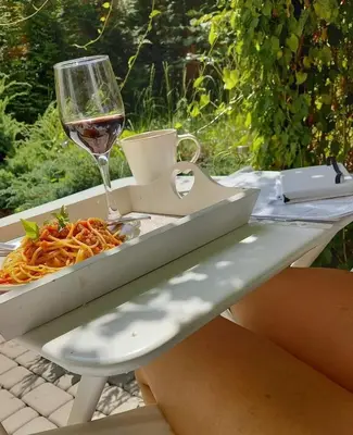 a table with a glass of wine and a tray of food at Centrum Krakowa, apartament z ogrodem i parkingiem in Kraków