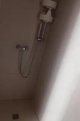 a shower in a bathroom with a shower head at Centrum Krakowa, apartament z ogrodem i parkingiem in Kraków