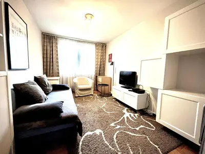 a living room with a couch and a television at Apartament Reja 11 in Kraków