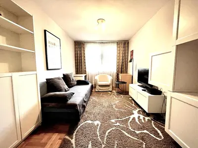 a hallway with a wooden door and a mirror at Apartament Reja 11 in Kraków