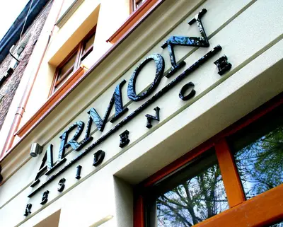 a sign on the side of a building at Armon Residence in Kraków