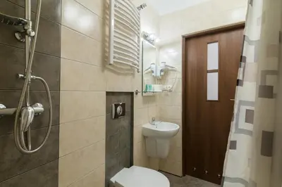 a bathroom with a toilet and a sink at Astra Apartments in Oświęcim