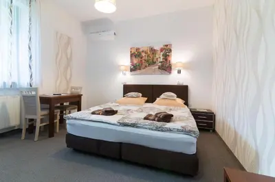 a bedroom with a bed with two dogs laying on it at Astra Apartments in Oświęcim