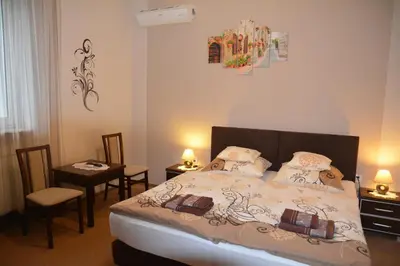 a bedroom with a bed and a table and chairs at Astra Apartments in Oświęcim