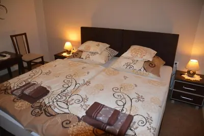 a bedroom with a bed with two bags on it at Astra Apartments in Oświęcim