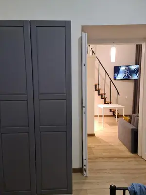 a sliding door in a room with a living room at Amber Hostel in Kraków