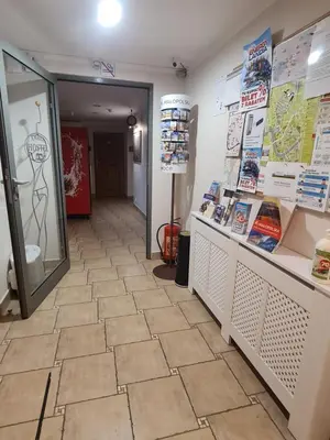 a store hallway with a tile floor and a mirror at Amber Hostel in Kraków