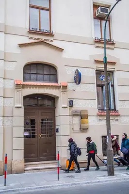 a group of people walking in front of a building at Amber Hostel in Kraków