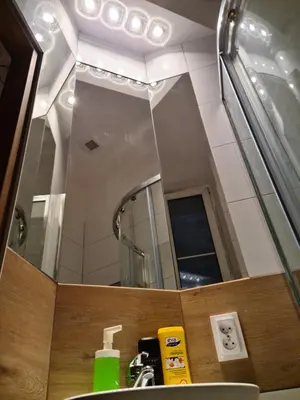 a bathroom with a sink and a mirror at Amber Hostel in Kraków