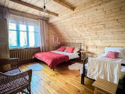 a bedroom with two beds in a log cabin at Makowy Domek in Maków Podhalański