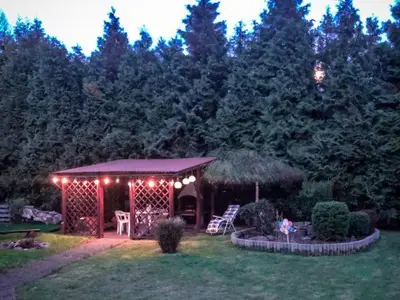 a garden with a gazebo with lights on it at Makowy Domek in Maków Podhalański