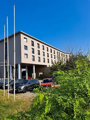 a building with cars parked in front of it at Sympo Apartments in Kraków