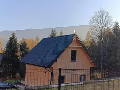 a barn with a solar roof on top of it at Zawojska Kapryśnica Zawoja Górna 2970 in Zawoja