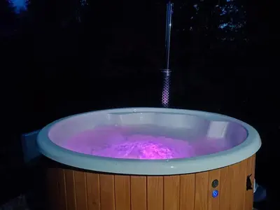a hot tub with pink water in it at Zawojska Kapryśnica Zawoja Górna 2970 in Zawoja