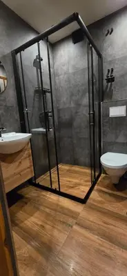 a bathroom with a shower with a toilet and a sink at Chałupa na Wierzchowinie in Limanowa