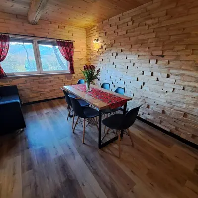 a dining room with a table and chairs at Chałupa na Wierzchowinie in Limanowa