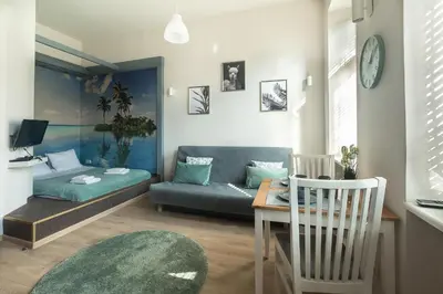 a living room with a couch and a table at Enios Apartments Długa 60 in Kraków