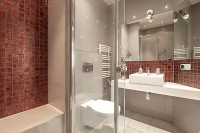a bathroom with a toilet and a sink and a shower at Enios Apartments Długa 60 in Kraków