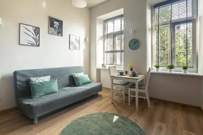 a living room with a couch and a table at Enios Apartments Długa 60 in Kraków