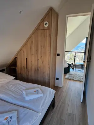 a bedroom with a bed with a wooden headboard at CzarnyHetman in Grzechynia