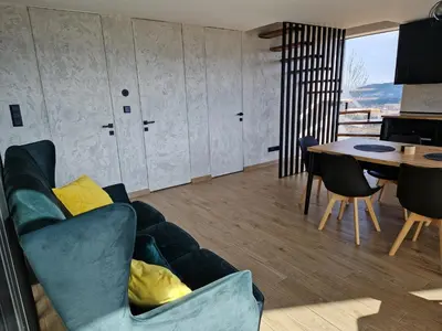 a living room with a couch and a table at CzarnyHetman in Grzechynia