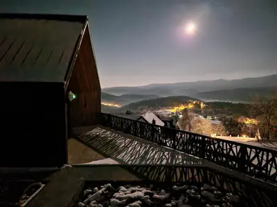 a view from the balcony of a building at night at CzarnyHetman in Grzechynia