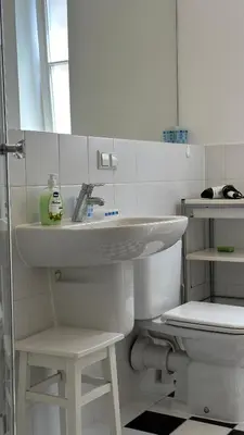 a white bathroom with a sink and a toilet at Two Bedrooms City Center Krakow in Kraków