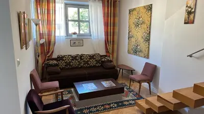 a living room with a couch and a table at Two Bedrooms City Center Krakow in Kraków