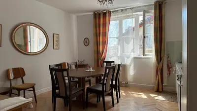 a dining room with a table and chairs and a mirror at Two Bedrooms City Center Krakow in Kraków