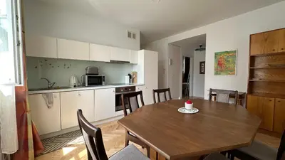 a kitchen and dining room with a table and chairs at Two Bedrooms City Center Krakow in Kraków