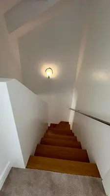 a staircase in a room with a light on the ceiling at Two Bedrooms City Center Krakow in Kraków