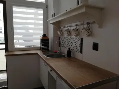a kitchen counter with a sink and a window at Red Carpet Hostel in Kraków