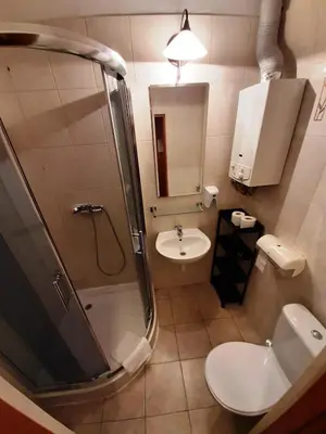 a bathroom with a shower and a toilet and a sink at Red Carpet Hostel in Kraków