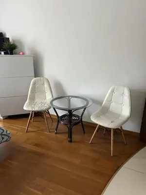 two chairs and a glass table in a room at KR apartment in Kraków