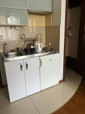 a kitchen with white cabinets and a sink at KR apartment in Kraków