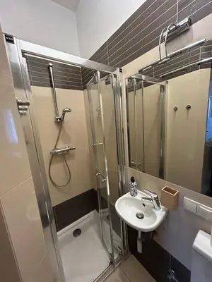 a bathroom with a shower and a sink at KR apartment in Kraków