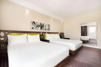 two beds in a hotel room at Hampton by Hilton Krakow in Kraków