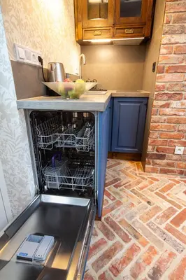 an open dishwasher in a kitchen with a sink at Yesblisko in Kraków