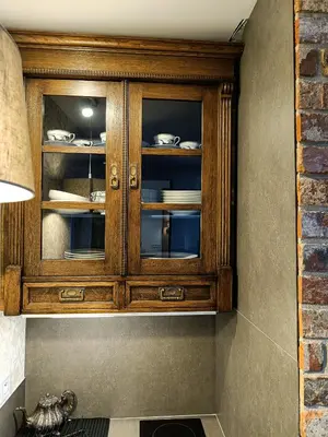 a wooden cabinet with dishes in it at Yesblisko in Kraków