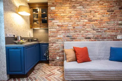 a living room with a brick wall and a couch at Yesblisko in Kraków